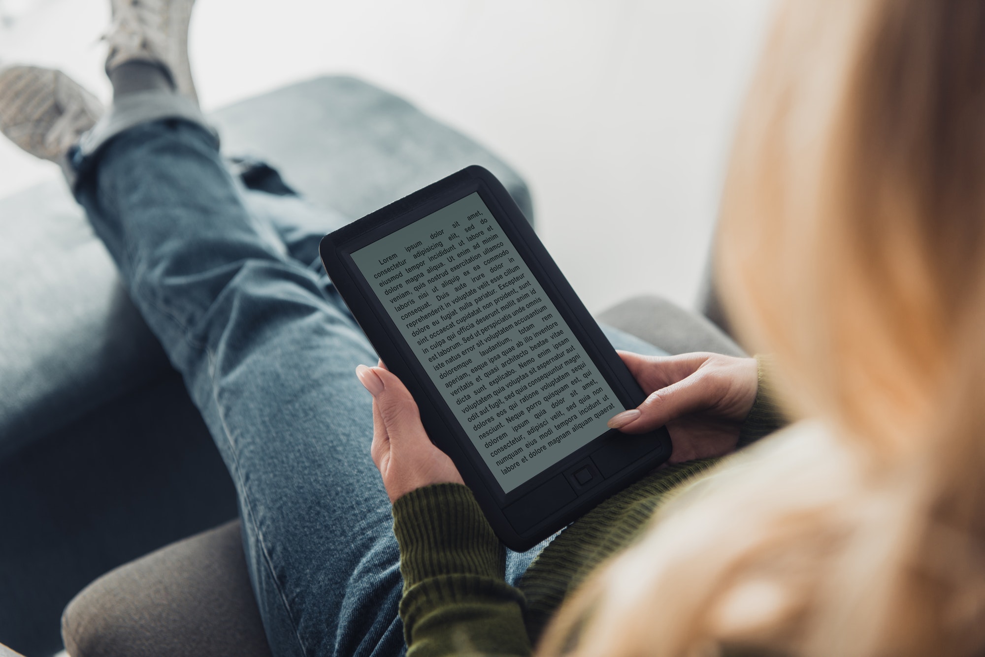 cropped view of woman reading ebook at home